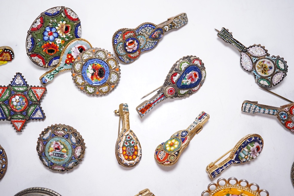 A collection of thirty-one micro-mosaic brooches, including fourteen mixed guitar and banjo shaped brooches, six large oval brooches and seven smaller brooches, three long brooches and a star shaped brooch. Condition - g